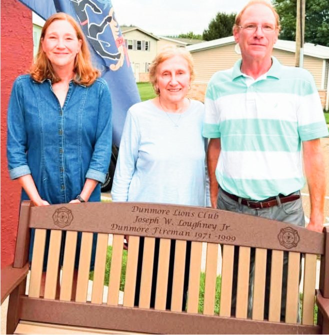 Catherine, Nancy and Joseph Needham are shown following the dedication of a bench in memory of Joseph W. Dougherty Jr.